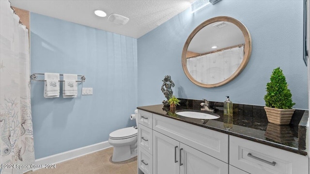 bathroom with toilet, a textured ceiling, vanity, and tile patterned flooring