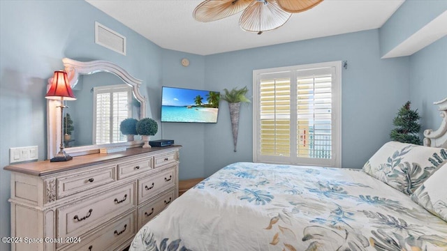 bedroom with ceiling fan and multiple windows