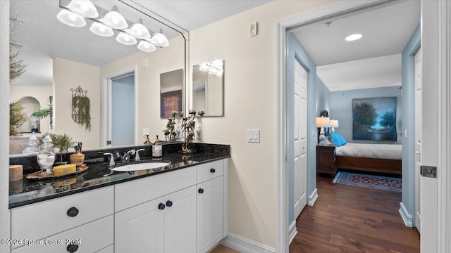 bathroom with vanity, a textured ceiling, and hardwood / wood-style flooring