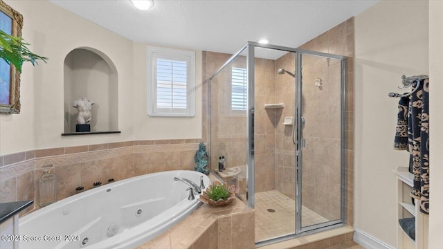 bathroom featuring shower with separate bathtub