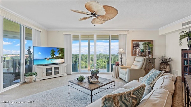 living room featuring crown molding, plenty of natural light, and ceiling fan