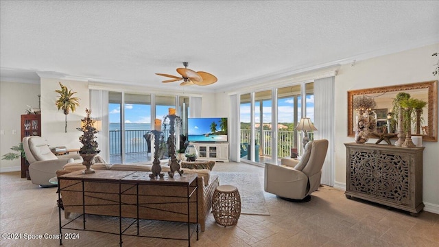 living room with ceiling fan, ornamental molding, a textured ceiling, and floor to ceiling windows