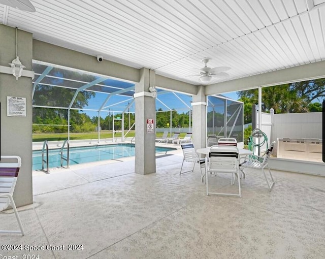 view of pool with a lanai, a patio area, and ceiling fan