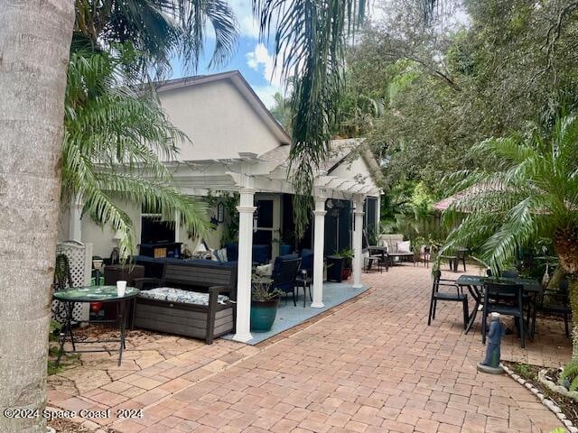 view of patio / terrace featuring an outdoor hangout area and a pergola