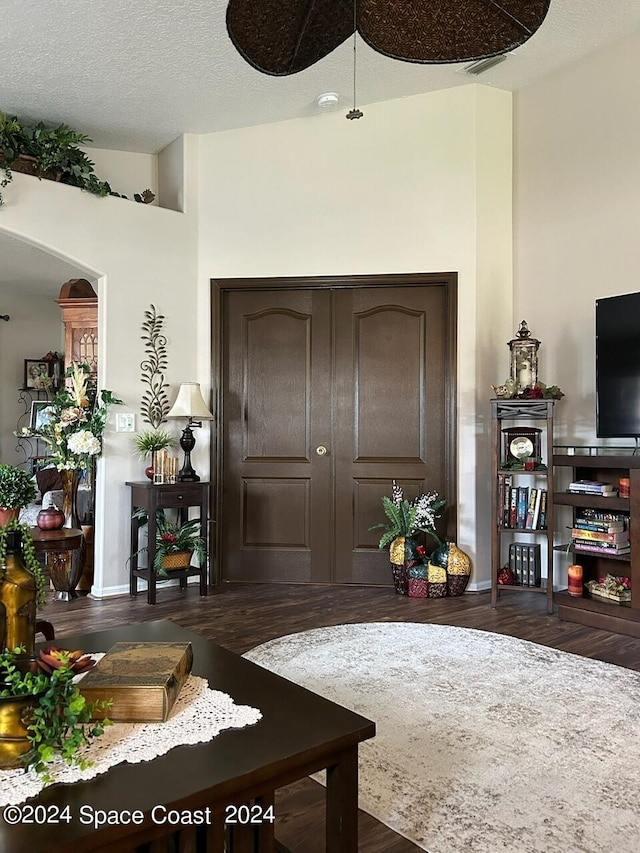 interior space featuring dark hardwood / wood-style flooring and a textured ceiling