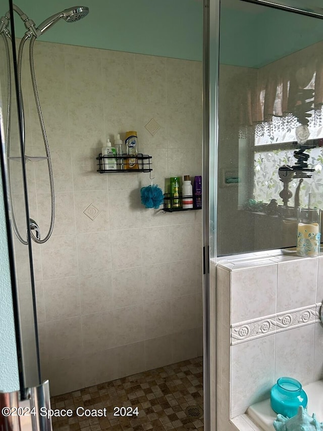 bathroom with a shower with door