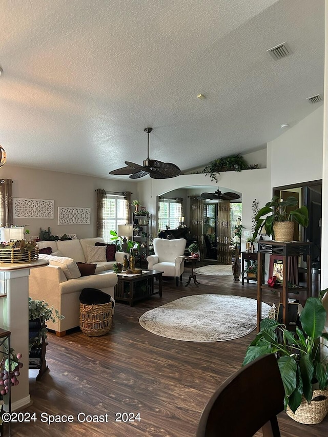 living room with ceiling fan, dark hardwood / wood-style flooring, and a textured ceiling