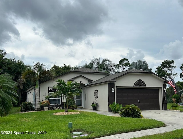 single story home featuring a garage and a front lawn