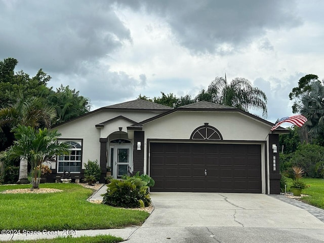 ranch-style house featuring a front lawn and a garage