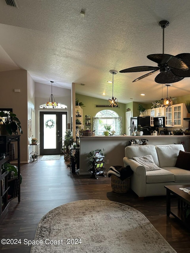 living room featuring a textured ceiling, ceiling fan, lofted ceiling, and dark wood-type flooring