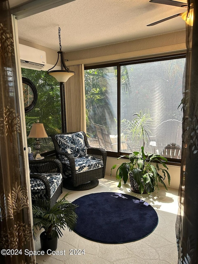 sunroom / solarium featuring ceiling fan and an AC wall unit