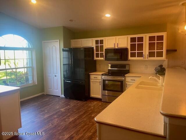 kitchen with sink, white cabinetry, plenty of natural light, and black appliances