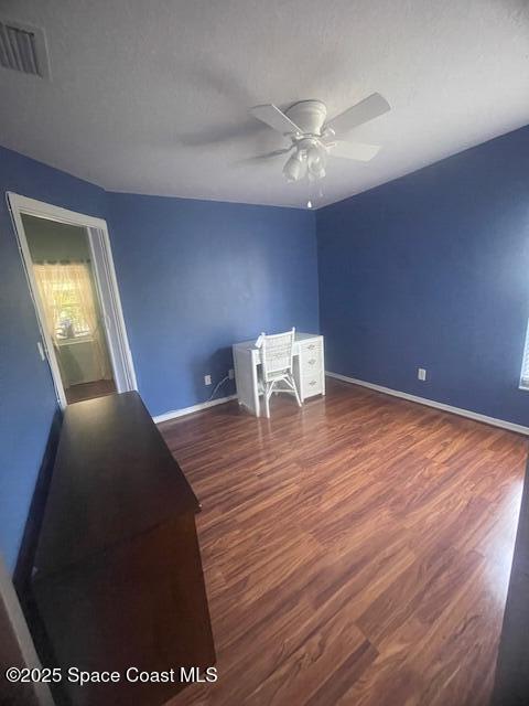 interior space featuring dark hardwood / wood-style floors and ceiling fan