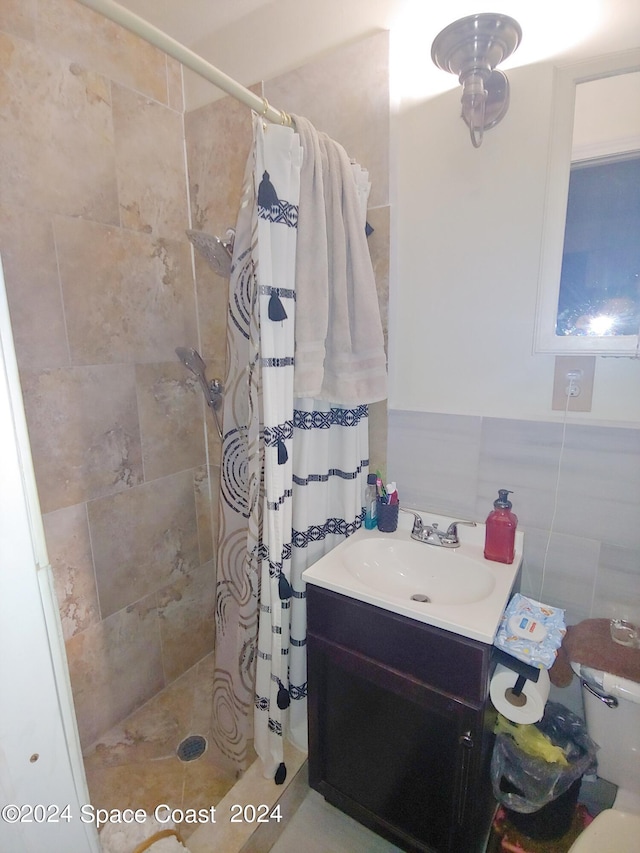 bathroom featuring vanity, a shower with curtain, toilet, and tile walls