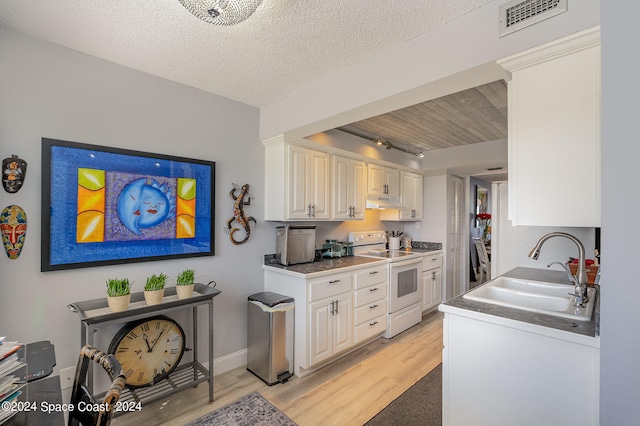 kitchen featuring light hardwood / wood-style floors, white cabinets, a textured ceiling, white range with electric stovetop, and sink