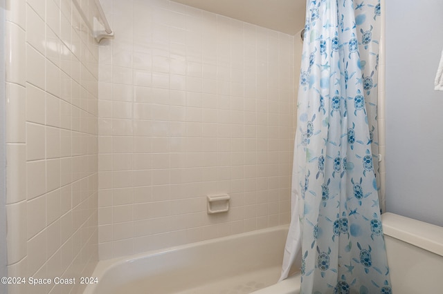 bathroom with toilet and shower / bathtub combination with curtain