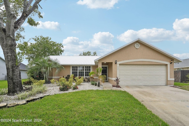 ranch-style house featuring a garage and a front lawn