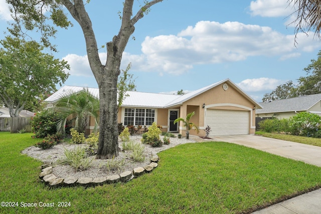 ranch-style home with a garage and a front lawn