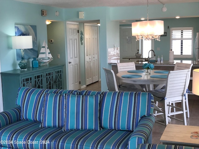 tiled living room featuring a notable chandelier and sink