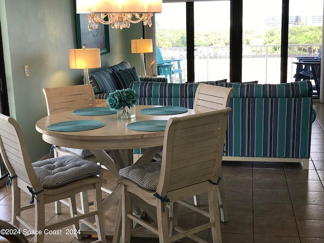 tiled dining space with a chandelier and a wealth of natural light