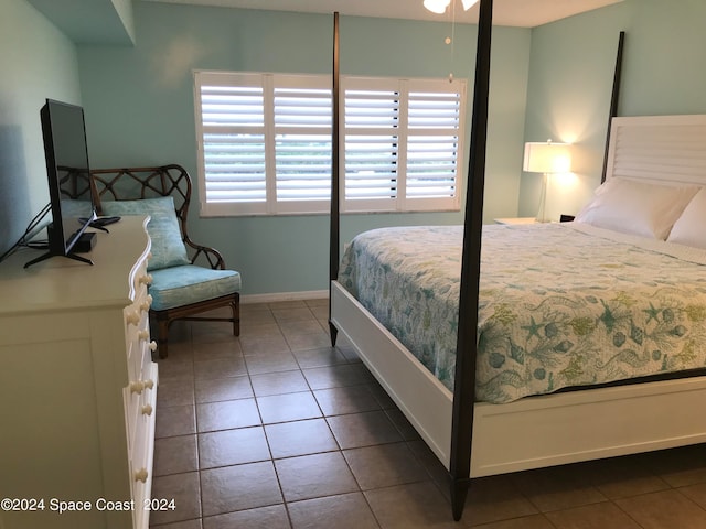 bedroom with dark tile patterned floors