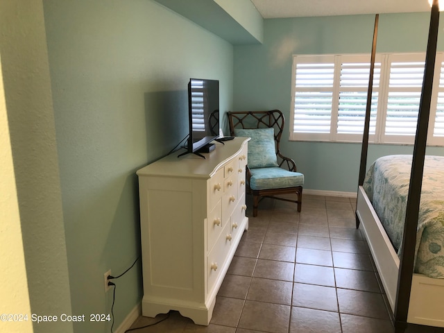 bedroom with dark tile patterned flooring