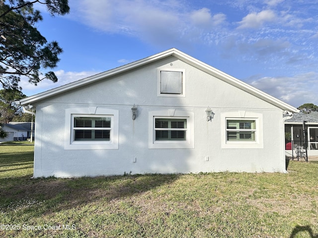 view of home's exterior featuring a lawn and stucco siding