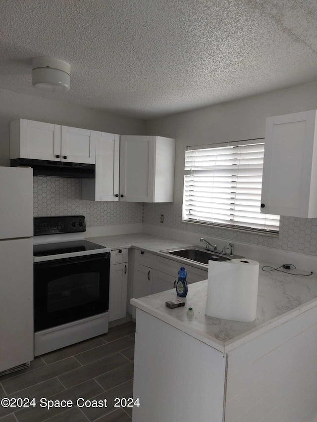 kitchen with white appliances, tasteful backsplash, white cabinetry, and sink