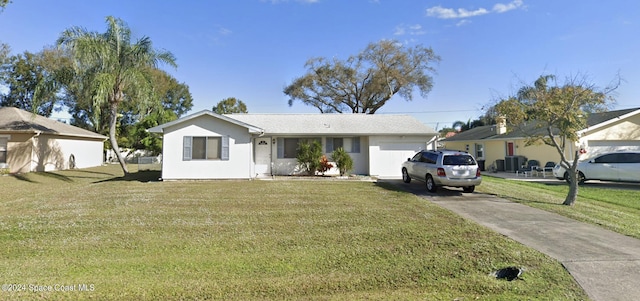 single story home featuring a front lawn and a garage