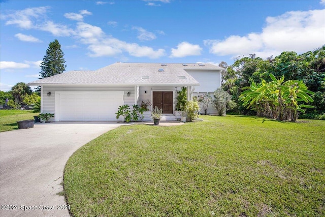 view of front of house with a front lawn and a garage