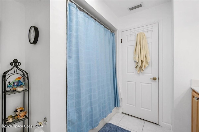 bathroom featuring tile patterned flooring, vanity, and a shower with shower curtain