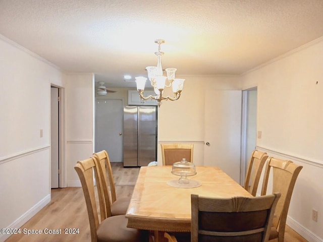 dining room with ceiling fan, ornamental molding, a textured ceiling, and light hardwood / wood-style floors