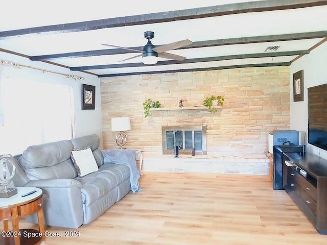 living room featuring light hardwood / wood-style floors, beam ceiling, and ceiling fan