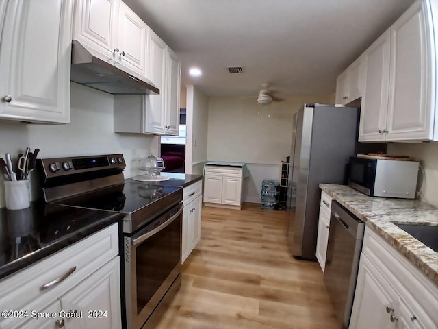 kitchen with white cabinetry, light hardwood / wood-style flooring, stainless steel appliances, dark stone countertops, and ceiling fan