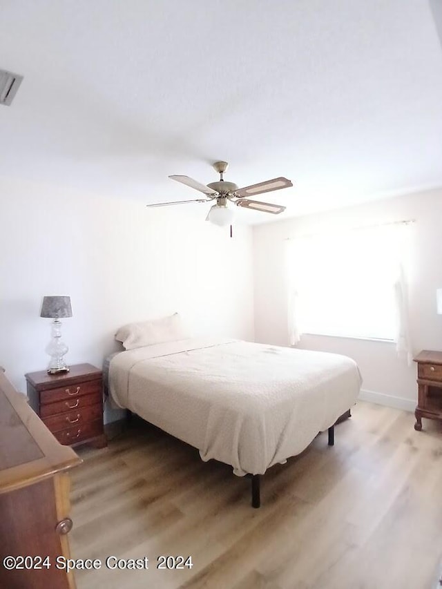 bedroom featuring wood-type flooring and ceiling fan