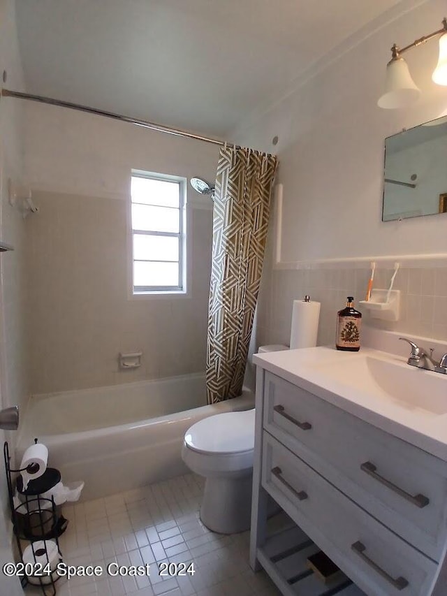 full bathroom with tile walls, shower / tub combo, vanity, tile patterned flooring, and toilet