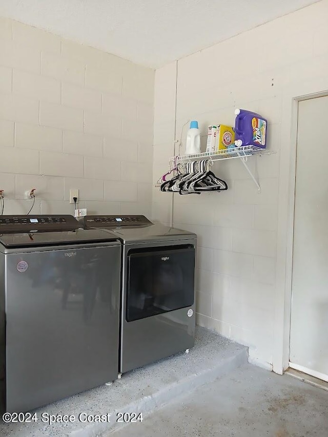 laundry area featuring washing machine and clothes dryer