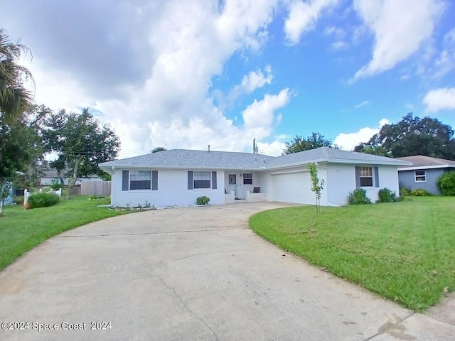 ranch-style house featuring a garage and a front lawn