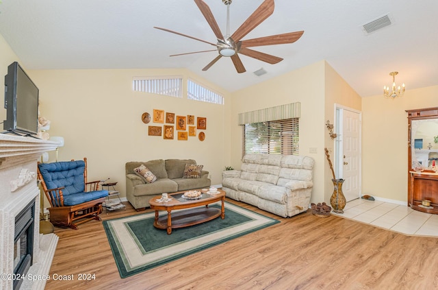 1531 Independence Ave, Melbourne, FL 32940 - living room featuring ceiling fan with notable chandelier, lofted ceiling, a fireplace, and visible vents