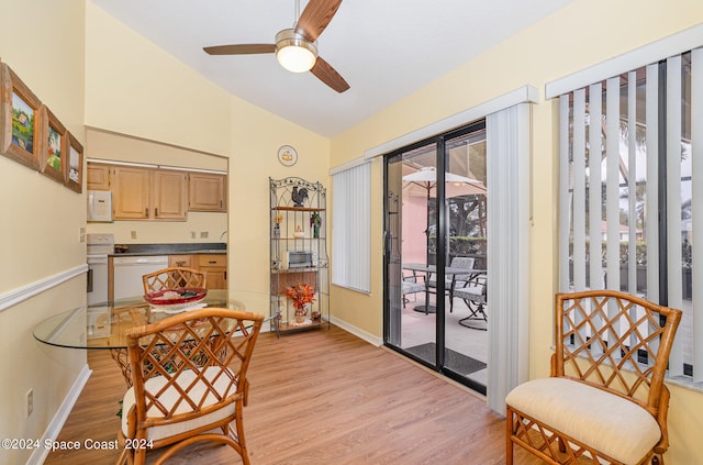 dining area featuring lofted ceiling, plenty of natural light, and light wood-type flooring