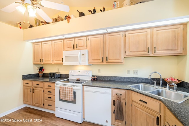 1531 Independence Ave, Melbourne, FL 32940 - kitchen featuring a sink, dark countertops, light brown cabinetry, and white appliances