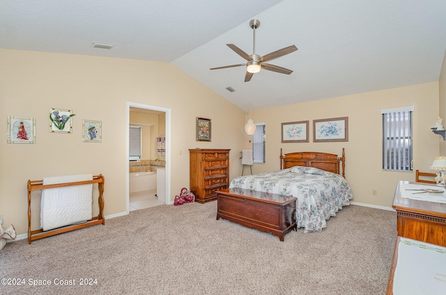 carpeted bedroom featuring lofted ceiling, ceiling fan, and ensuite bath