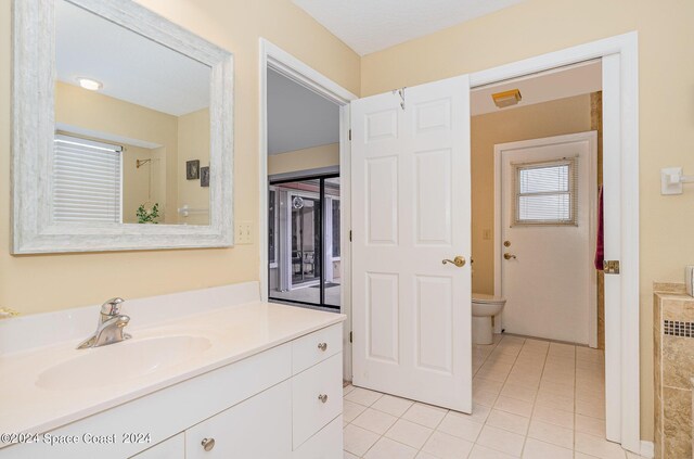 bathroom with tile patterned floors, toilet, and vanity