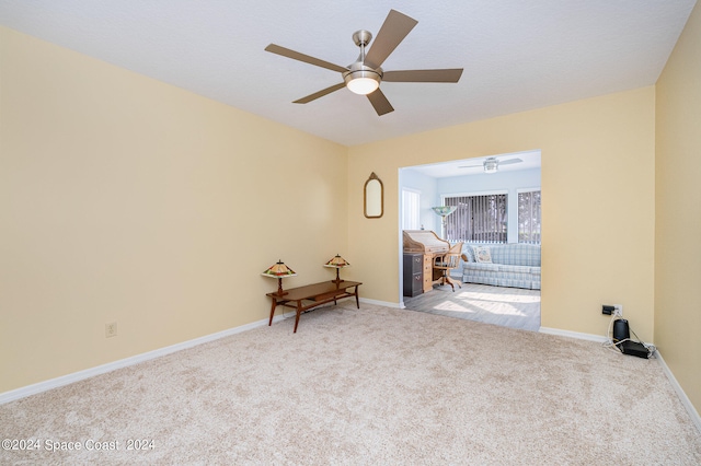 carpeted empty room with ceiling fan