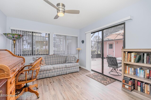 sitting room with ceiling fan and light wood-type flooring