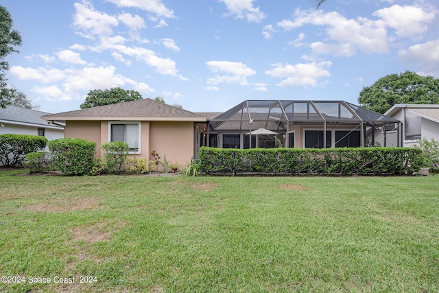 1531 Independence Ave, Melbourne, FL 32940 - back of house with stucco siding, a yard, and a lanai