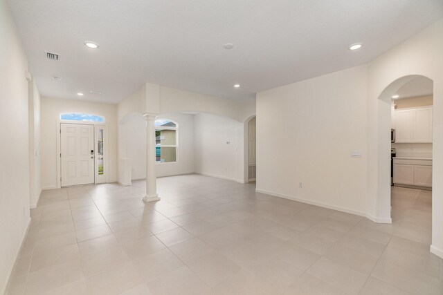 unfurnished room with decorative columns