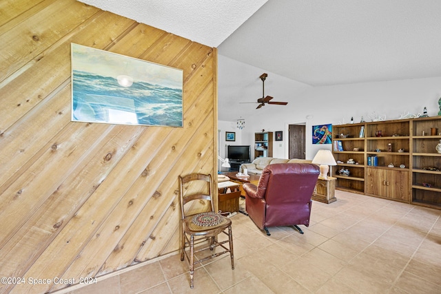 living room featuring ceiling fan and vaulted ceiling