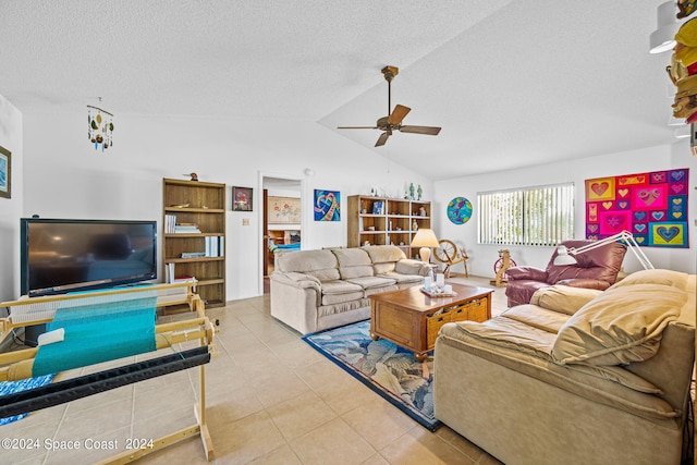 living room with ceiling fan, a textured ceiling, lofted ceiling, and light tile patterned floors