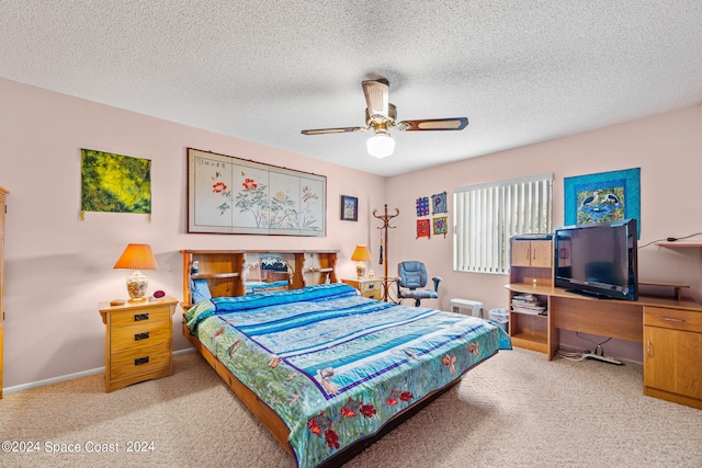 carpeted bedroom with ceiling fan and a textured ceiling